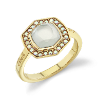 A gold ring with an octagonal, translucent center stone, surrounded by a border of small, round white gems, set against a plain background.